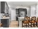 Well-equipped kitchen with dark wood cabinets, stainless steel appliances, and a breakfast bar at 3811 Queen Elizabeth Ct, Laughlin, NV 89029