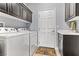 Functional laundry room with washer, dryer, sink, and ample storage space at 3811 Queen Elizabeth Ct, Laughlin, NV 89029