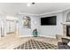 View of a spacious living room area featuring tiled floors, a fireplace, and a large TV at 3811 Queen Elizabeth Ct, Laughlin, NV 89029