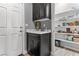 Convenient mud room with built-in shelving and a stylish dark cabinet and sink at 3811 Queen Elizabeth Ct, Laughlin, NV 89029
