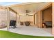 Extended covered patio featuring a grill, seating, and rock wall at 3811 Queen Elizabeth Ct, Laughlin, NV 89029