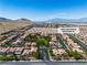 Aerial view shows the beautiful community against mountain backdrop and desert landscape at 4016 Owlshead Mountain St, Las Vegas, NV 89129