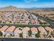 Aerial view of neighborhood and major roadway with mountains in background at 4016 Owlshead Mountain St, Las Vegas, NV 89129