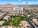 An aerial perspective of the neighborhood park with green space and the surrounding homes at 4016 Owlshead Mountain St, Las Vegas, NV 89129