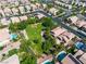 This aerial view captures the neighborhood park with lush landscaping, walking paths, and community pools at 4016 Owlshead Mountain St, Las Vegas, NV 89129
