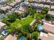 Aerial view of neighborhood park with lush landscaping, walking paths and community pools at 4016 Owlshead Mountain St, Las Vegas, NV 89129