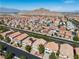 This aerial view shows a beautiful landscape, homes with well-kept yards, and mountain views at 4016 Owlshead Mountain St, Las Vegas, NV 89129