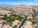 A neighborhood shot complete with desert landscaping, solar panels, and paved streets at 4016 Owlshead Mountain St, Las Vegas, NV 89129