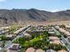 This aerial shot showcases the neighborhood with mountain views, featuring homes with well-maintained landscaping and desert surroundings at 4016 Owlshead Mountain St, Las Vegas, NV 89129