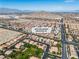 Stunning aerial view of a residential community nestled near a majestic mountain range in a desert landscape at 4016 Owlshead Mountain St, Las Vegas, NV 89129