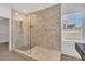 Bright bathroom featuring a walk-in shower with tile surround and glass door at 4016 Owlshead Mountain St, Las Vegas, NV 89129