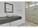Modern bathroom featuring a unique vessel sink, stone countertop, and glass enclosed shower with mosaic floor at 4016 Owlshead Mountain St, Las Vegas, NV 89129