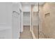 Modern bathroom featuring large walk-in shower, towel bar and open door to walk-in closet at 4016 Owlshead Mountain St, Las Vegas, NV 89129