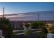 Sunset view overlooking homes with Las Vegas skyline and mountain backdrop at 4016 Owlshead Mountain St, Las Vegas, NV 89129