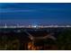 Striking Las Vegas skyline view from this home, showcasing the city's vibrant lights at dusk at 4016 Owlshead Mountain St, Las Vegas, NV 89129