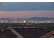 Expansive Las Vegas skyline view from rooftop with mountains and sunset hues at 4016 Owlshead Mountain St, Las Vegas, NV 89129