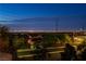 A nighttime view of the Las Vegas skyline from the community, highlighting neighborhood street at 4016 Owlshead Mountain St, Las Vegas, NV 89129