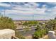 A distant view of city lights from atop a neighborhood street framed by trees at 4016 Owlshead Mountain St, Las Vegas, NV 89129
