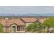 A view of the Las Vegas skyline from a neighborhood, showcasing red-tiled rooftops at 4016 Owlshead Mountain St, Las Vegas, NV 89129
