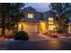 Inviting home exterior with a landscaped front yard, a two-car garage, and elegant architectural details at 4016 Owlshead Mountain St, Las Vegas, NV 89129