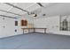 Clean garage features sealed floors, work bench, and overhead storage at 4016 Owlshead Mountain St, Las Vegas, NV 89129