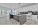 Modern kitchen featuring a large center island, sleek cabinets, and stainless steel appliances at 4016 Owlshead Mountain St, Las Vegas, NV 89129