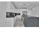 A well-equipped kitchen featuring white cabinets, black backsplash, and a gray island with sink at 4016 Owlshead Mountain St, Las Vegas, NV 89129