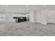 Expansive living area with modern kitchen, stone tile flooring, and abundant natural light at 4016 Owlshead Mountain St, Las Vegas, NV 89129
