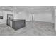 Open-concept living space with stone tile flooring and recessed lighting, perfect for modern living at 4016 Owlshead Mountain St, Las Vegas, NV 89129