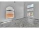 Open-concept living area with large windows, neutral walls, and tiled flooring at 4016 Owlshead Mountain St, Las Vegas, NV 89129