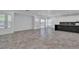 An open living space features stone tile flooring, recessed lighting, and a seamless flow to the kitchen at 4016 Owlshead Mountain St, Las Vegas, NV 89129