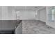 Spacious living area with stone tile flooring, recessed lighting, and neutral color palette at 4016 Owlshead Mountain St, Las Vegas, NV 89129