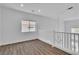 Bright and airy loft with natural light, wood floors, and a modern railing overlooking the downstairs area at 4016 Owlshead Mountain St, Las Vegas, NV 89129