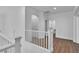 Spacious loft area with modern railing, wood floors, natural light, and easy access to the laundry area at 4016 Owlshead Mountain St, Las Vegas, NV 89129