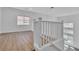 Bright and airy loft with natural light, wood floors, and a modern railing overlooking the main floor at 4016 Owlshead Mountain St, Las Vegas, NV 89129