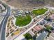 An aerial view of Trigono Hills Park highlights its playgrounds, green spaces, and walking paths at 4016 Owlshead Mountain St, Las Vegas, NV 89129