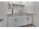 A bathroom vanity features double sinks and white cabinets with granite countertops at 4448 Mahogany Hills Ave, Las Vegas, NV 89141