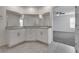 Bathroom features a granite countertop vanity with double sinks and tile flooring at 4448 Mahogany Hills Ave, Las Vegas, NV 89141
