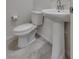 Powder room featuring a pedestal sink and modern toilet at 4448 Mahogany Hills Ave, Las Vegas, NV 89141