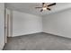Spacious bedroom with neutral colored carpet, fan and ample electrical outlets at 4448 Mahogany Hills Ave, Las Vegas, NV 89141
