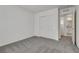 A simple bedroom with neutral carpet, white walls, and a double closet at 4448 Mahogany Hills Ave, Las Vegas, NV 89141