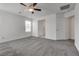 Bright bedroom features neutral carpet, ceiling fan, and ensuite bathroom at 4448 Mahogany Hills Ave, Las Vegas, NV 89141