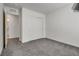A simple bedroom with neutral carpet and white walls, and a double closet at 4448 Mahogany Hills Ave, Las Vegas, NV 89141