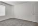 A simple bedroom featuring neutral carpet, white walls, and a window at 4448 Mahogany Hills Ave, Las Vegas, NV 89141