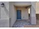 Covered entrance with a blue front door and stone paver landing at 4448 Mahogany Hills Ave, Las Vegas, NV 89141
