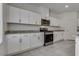 Bright kitchen featuring white cabinets, granite countertops, and stainless steel appliances at 4448 Mahogany Hills Ave, Las Vegas, NV 89141