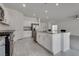 Open kitchen design showcasing an island with counter seating and stainless steel appliances at 4448 Mahogany Hills Ave, Las Vegas, NV 89141