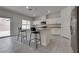 Island kitchen features granite countertops, white cabinets and breakfast bar at 4448 Mahogany Hills Ave, Las Vegas, NV 89141