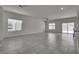 Spacious living room with tile flooring, fan, and sliding glass door at 4448 Mahogany Hills Ave, Las Vegas, NV 89141
