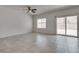Bright living room featuring tile flooring, a ceiling fan, and sliding glass doors at 4448 Mahogany Hills Ave, Las Vegas, NV 89141